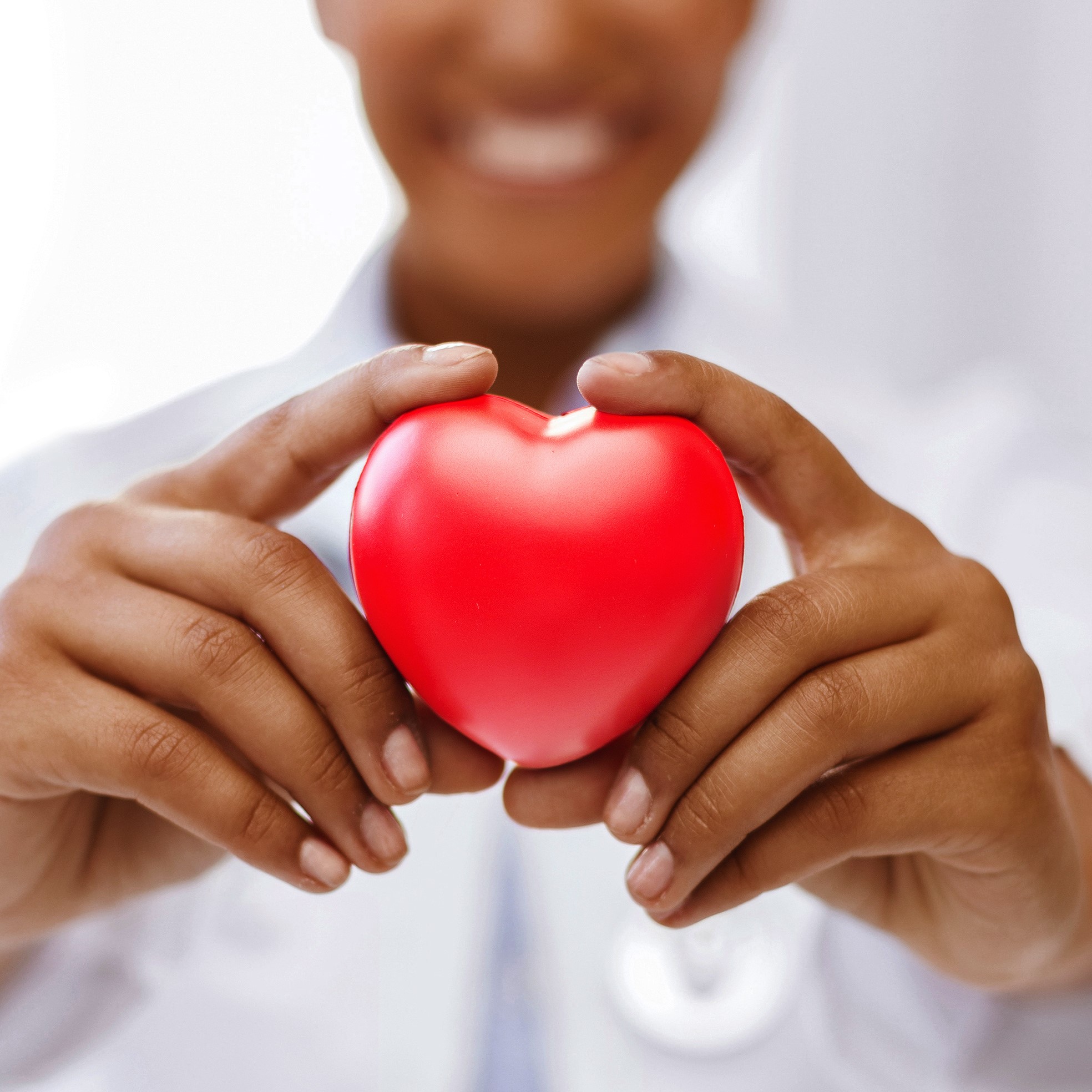 african female doctor with red heart